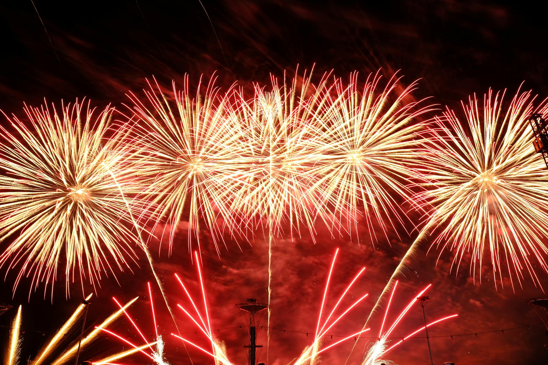 Spectacular fireworks lighting up a clear night sky in vibrant colors.